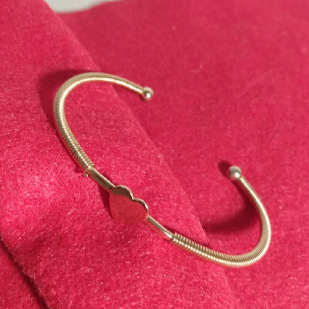 Sarah: Gold Tone Open Bracelet With Center Heart.